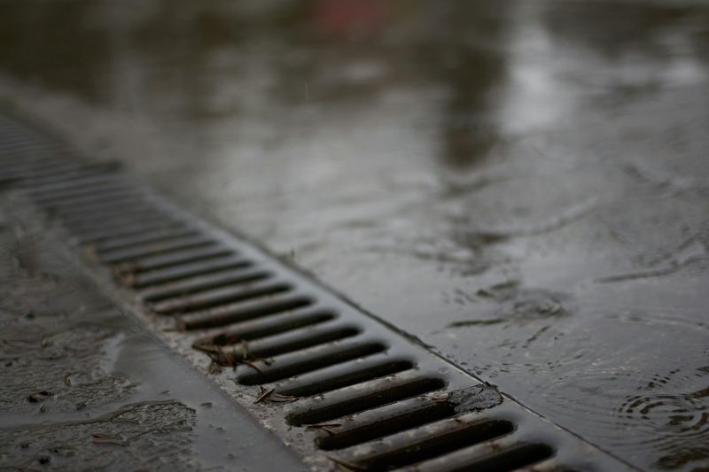 Metal channel drain set in a wet concrete floor